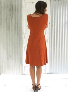 "The Oracle Dress is flattering yet modest, an ideal dress for a casual or professional look. You will want one in several different colors for sure. It is so soft and stretchy, and so comfortable you may never want to take it off. * Mid length dress * 3/4 sleeves * Scoop neck * Faux wrap skirt * Lettuce hem finishing * 25\" from waist to hem (can be customized) COLOR Pictured in Rust. See images and drop-down menu for all color options. SIZES Made to order in sizes XS-3X or Custom. See images f Chic Everyday Dress For Fall, Chic Solid Dress For Everyday, Elegant Fitted Midi Dress For Everyday, Solid Color Fitted Dress For Everyday Wear, Elegant Fitted Dresses For Everyday, Fitted Everyday Dress For Fall, Fall A-line Midi Dress, Everyday Fitted Dresses For Fall, Fitted Dresses For Everyday Fall Wear