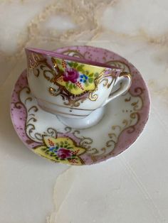 two cups and saucers on a marble table