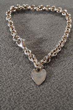 I am offering you this spectacular sterling silver (stamped) Classic fancy rolo link charm style bracelet. There is a heart shaped dangle charm. There is plenty of room to put additional charms on it. It has a very dimensional, sturdy and wide. There is a sturdy lobster claw closure. It measures approx. 7.5 inches in length, and is approx. 3/4 inch wide. It weighs app. 13 grams. Buyer pays all shipping and handling fees, we will always combine shipping. Classic Sterling Silver Charm Bracelet With Heart, Classic Silver Heart Charm Bracelet, Sterling Silver Heart Bracelet With Charms, Classic Silver Charm Bracelet For Valentine's Day, Heart-shaped Sterling Silver Charm Bracelet, Sterling Silver Charm Bracelet With Rolo Chain, Sterling Silver Charm Bracelet With Rolo Chain For Gift, Sterling Silver Rolo Chain Charm Bracelet Gift, Sterling Silver Charm Bracelet With Heart Dangle