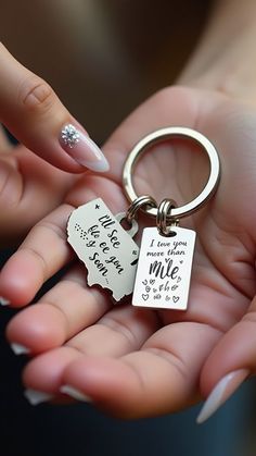 a person holding a keychain that says i love you to the moon and back