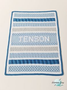 a blue and white crocheted afghan with the name jennyson written on it