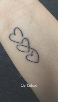 a tattoo with two hearts on the arm