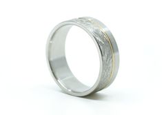 a white gold and silver wedding ring on a white background