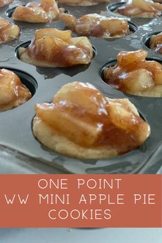 mini apple pies in a muffin tin with caramel glaze