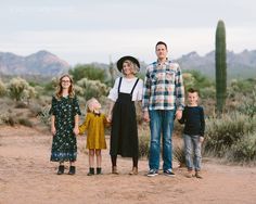 a family standing in the desert holding hands