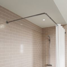 a bathroom with a shower head, toilet and bathtub