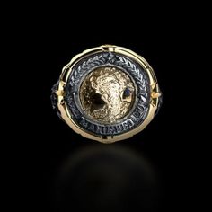 a gold and silver ring with an image of the moon in it's center