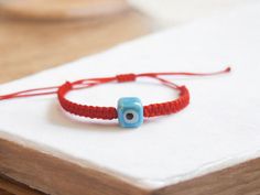 It is rumored that the evil eye bead has been protecting from bad energies since ancient times. For this reason, it has been used as a protective jewelry for centuries. Red cord bracelets are thought to bring luck according to Tibe Buddhist belief. We combined the protective evil eye bead with lucky red string Kabbalah Bracelets. We used evil eye beads in the form of ceramic cubes on our bracelets. It is the cube ceramic evil eye bead that distinguishes this model from ordinary evil eye bracelet Adjustable Amulet Bracelets As Gift, Adjustable Amulet Bracelet Gift, Adjustable Amulet Bracelet As Gift, Bohemian Evil Eye Bracelet With Adjustable Cord As Gift, Spiritual Evil Eye Bracelet With Adjustable Cord, Spiritual Evil Eye Bracelet With Adjustable Cord As Gift, Spiritual Evil Eye Bracelet With Adjustable Length, Casual Evil Eye Friendship Bracelets As Gift, Casual Evil Eye Friendship Bracelets For Gifts