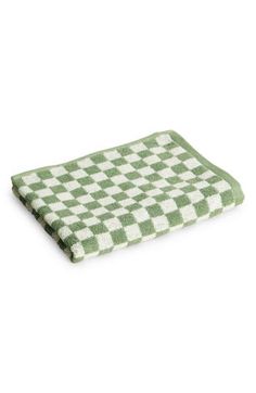 a green and white checkered towel on a white background