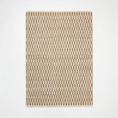 a brown and white rug on a white wall