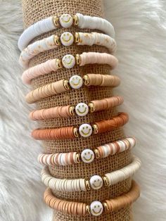 a stack of bracelets with buttons on them