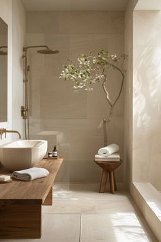 a bathroom with a tree in the middle of it and two sinks on each side