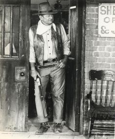 John Wayne in El Dorado, wearing his Red River D belt buckle from Red River in 1948.