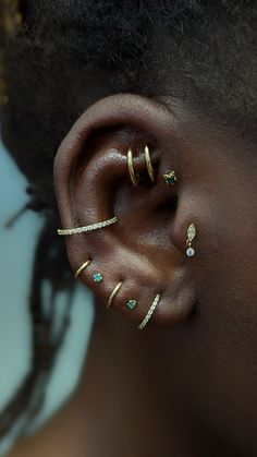 a close up of a person with ear piercings on their left and right sides