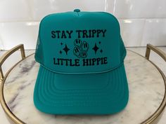 STAY TRIPPY LITTLE HIPPIE TRUCKER HAT WITH SMILEY FACE + High quality adjustable trucker hat + Hat color and font color can be adjusted - please message me directly to customize HAT DETAILS: 100% Polyester Front 100% Polyester Mesh Back The Traditional Look 5-panel cap Seamless Foam Front Panel with Lining Matching Color Braid 8 Rows Stitching on Visor Matching Fabric Undervisor Matching Color Sweatband Plastic Adjustable Snap All items are made to order and therefore cannot be returned or excha Playful Green Adjustable Trucker Hat, Green Letter Print Trucker Hat For Beach, Playful Adjustable Green Trucker Hat, Green Summer Trucker Hat With Letter Print, Green Letter Print Trucker Hat For The Beach, Summer Green Trucker Hat With Letter Print, Green Trucker Hat With Letter Print For The Beach, Green Trucker Hat With Letter Print For Summer, Cute Adjustable Mini Hats For Festivals