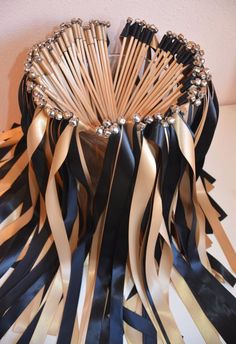 black and gold ribbons in a vase on a table