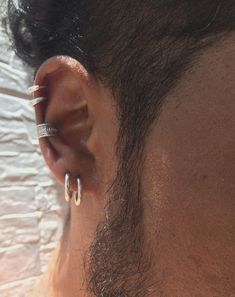 a man with ear piercings on top of his head