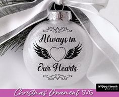 christmas ornament svg always in our hearts with wings and heart on it