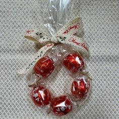 four christmas candies wrapped in cellophane on a table