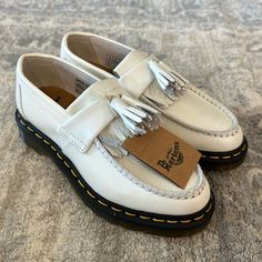 Brand New With Tags. Men’s Size 5/Women’s Size 7 Casual Tassel Loafers With Branded Insole, White Leather Casual Tassel Loafers, Casual White Leather Tassel Loafers, White Leather Tassel Loafers For Spring, White Tassel Loafers With Round Toe For Spring, White Moccasins With Brogue Detailing And Round Toe, White Moccasins With Brogue Detailing, Casual Wingtip Moccasins For Spring, White Leather Slip-on Loafers