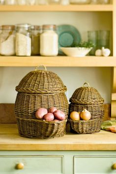 two wicker baskets sitting on top of a wooden counter next to other kitchen items