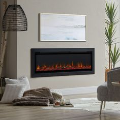 a living room with a couch, chair and fire place in the fireplace that is lit