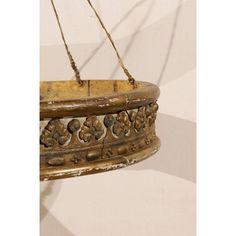 an old wooden hanging basket with flowers on it