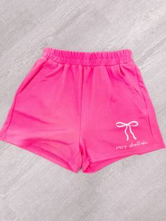 Meet the Sassy Bow Shorts from Sassy Shortcake: perfect for keeping comfy, cool, and cute! These basic hot pink shorts feature a light pink bow with the text Sassy Shortcake and stretchy elastic waistband that make them the ideal lounge wardrobe staple. So hop into your newest look with Sassy Bow Shorts - The ultimate in comfy and casual style! fit: true to size (model wearing size small) care: hand wash cold content: 65% cotton 35% polyester Cute Pink Loungewear Shorts, Cute Pink Shorts For Loungewear, Cute Shorts With Elastic Waistband For Loungewear, Pink Cotton Pajama Shorts For Leisure, Pink Pajama Shorts For Leisure, Pink High-waisted Shorts For Loungewear, Trendy Pink Shorts With Elastic Waistband, Pink Letter Print Short Bottoms, Cute Summer Bottoms With Letter Print