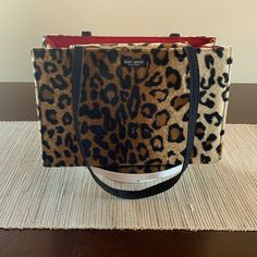 Euc Vintage Fuzzy Kate Spade Leopard Print Satchel With Gorgeous, Clean Red Interior. Magnetic Snap Closure Is Still Strong And Opens To One Interior Compartment That Includes A Generously Sized Zip Pocket. Handles Are Fabric And Lightly Faded, But All Stitching Is Intact. Top Flap Closure Does Have A Crease When Opened. I Love This Bag! Measurements 11” X 7.5” X 5” Handle Drop 10.25” Non Smoking Home. Leopard Print Bag, Vintage Leopard, Bag Measurements, Red Interior, Red Interiors, Snap Closure, Leopard Print, Kate Spade, Printer