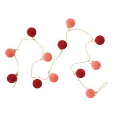 three red balls hanging from a gold chain