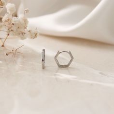 Mini Hexagon Hoop Huggie Earrings- This listing is for the Mini Hexagon Hoop Huggie(s)- Can be purchased as a single (1 earring, for one ear) or a pair (2 earrings, one for each ear)- Base Material: High Quality 925 Sterling Silver- Finish: 18K Gold - Measurement: 9mm inner diameter. Photo is a close up image for details. - Nickel Free- All our jewelry is packaged in gift ready boxes. If you would like multiple items from your order packaged separately please let us know! © 2023 Generation of Da 2 Earrings, Huggie Earrings, Silver Hoops, Gold Hoop Earrings, Huggies Earrings, Silver Hoop Earrings, Geometric Shapes, Close Up, 18k Gold