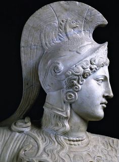 an ancient statue of a woman wearing a headdress