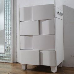 a white cabinet sitting on top of a hard wood floor