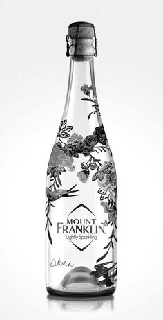 a glass bottle with flowers on it and the words mount franklin written in white lettering