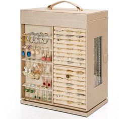 a wooden jewelry box filled with lots of earrings