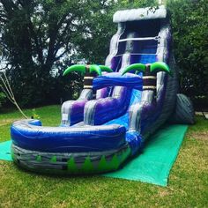 an inflatable water slide is on the grass