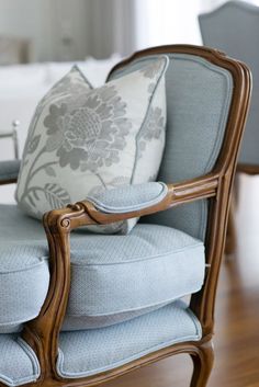 a blue chair with a pillow on top of it