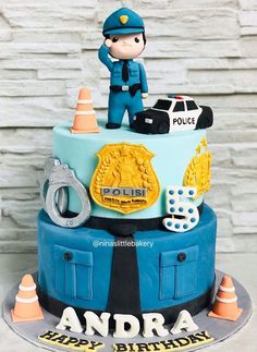 a birthday cake with a police officer on top