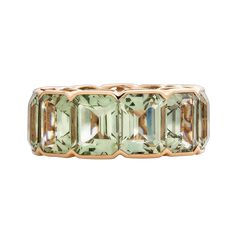 an 18k rose gold ring set with green tourmaline and baguets