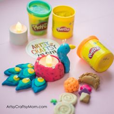 there are many toys on the table and one has a candle, some cookies, and other items