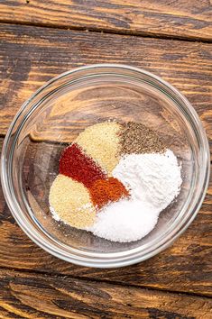 spices and seasonings in a glass bowl on a wooden table