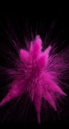 pink powder exploding in the air on a black background