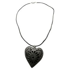 A heart-shaped charm adds strength to this beautiful necklace, this black clay jewel for women fits comfortably on all neck sizes. It is handcrafted with black clay by artists from Oaxaca, Mexico. This one-of-a-kind product is ready to make the ideal gift. It is an incredible surprise for any woman. Great gift for your mom or grandma on Mother's Day, anniversary, birthday, or wedding celebration. This delicate "Barro Negro" (black clay) piece is carefully handcrafted by artisans in San Bartolo C Black Adjustable Flower Pendant Necklace, Adjustable Black Flower Pendant Necklace, Artisan Carved Black Necklace, Artisan Black Carved Necklace, Black Heart-shaped Bohemian Jewelry, Artisan Adjustable Heart Necklace, Black Heart Shaped Bohemian Jewelry, Black Bohemian Heart-shaped Jewelry, Handmade Adjustable Black Heart Necklace