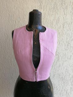 Jazzy pink waistcoat from the sixties. Perfectly lined and beautifully made in Italy Rounded zip puller at the front for a casual cool look Measurement: Length 43 cm Chest at widest point 39 cm Waist 33 cm Shoulder 32 cm UK Size 6 Fitted Pink Tops With Zipper Closure, Fitted Pink Top With Zipper Closure, Pink Fitted Top With Zipper, Pink Fitted Top With Zipper Closure, Spring Fitted Vest With Zipper Closure, Fitted Sleeveless Vest With Zipper Closure, Pink Waistcoat, Zip Puller, The Sixties