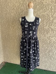 "Vintage black and white sleeveless fish print dress Made by Basic Editions Women's Size Small 60% Cotton and 40% Polyester. Material has stretch to it. Nice soft, comfortable material. It feels like a t-shirt. It has 2 pockets. In great condition. Measurements laying flat Armpit to armpit 17.5\" (35\" total) Across the waist 17\" (34\" total) Total length of dress 42\" Items are shipped out within 1-2 business days. If you have any questions please feel free to message me I reply quickly. Check Casual Printed Patterned Sleeveless Dress, Casual Patterned Printed Sleeveless Dress, Casual Sleeveless Printed Dress, Sleeveless Cotton Dress With Graphic Print, Vintage Floral Print Dress, Turtle Neck Crop Top, Vintage Black And White, Palm Desert, Butterfly Dress