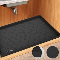 a bathroom with a black mat on the floor