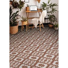 a living room with plants and a rug on the floor