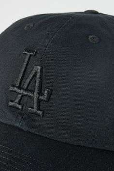 the los angeles dodgers hat is black and has an embroidered logo on the front side