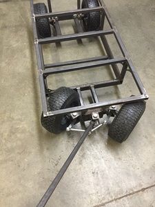 a trailer with four wheels on the floor