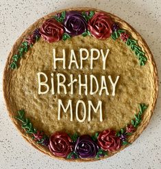 a birthday cake with the words happy birthday mom written in frosting and decorated with flowers